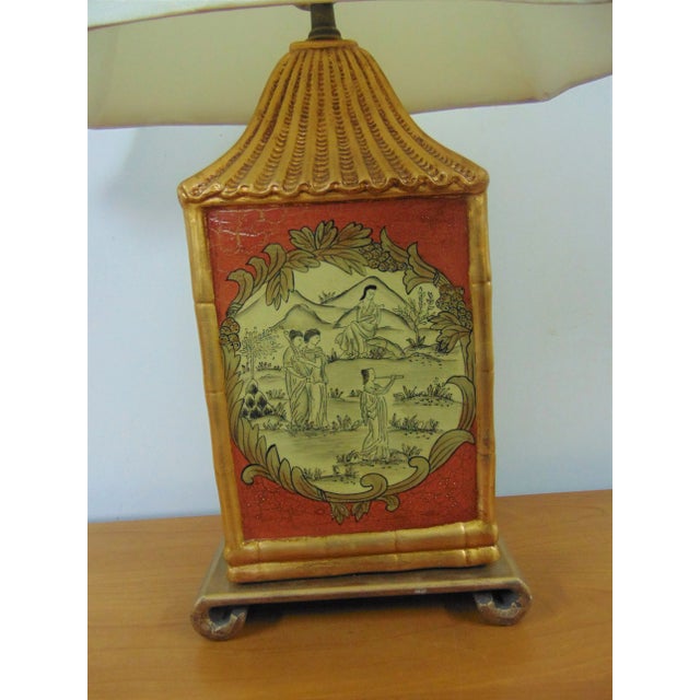 Chinoiserie style lamp, pagoda form, gold gilt and red crackle painted finish with Scenic grouping of woman on front side,...