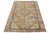 This vintage Persian wool rug features a light brown field with gray and blue accents throughout the design. This rug...