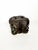A sculptural wooden ashtray, made in France in the 1950s, featuring four finely sculpted faces around a central shape....
