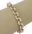 This authentic Knife Edge round link bracelet is finely crafted in solid 14k yellow and white gold, featuring a classic...