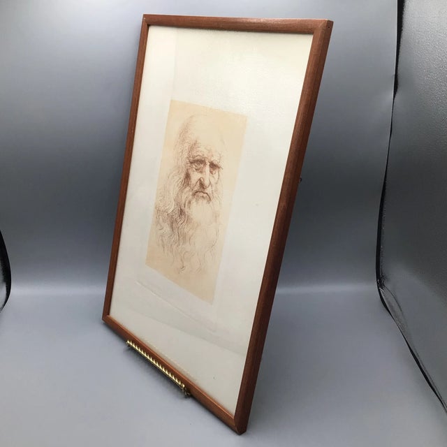 graphite copy of da Vinci's famous portrait in red chalk. Presented in a medium walnut wood frame. Unsigned. Description...