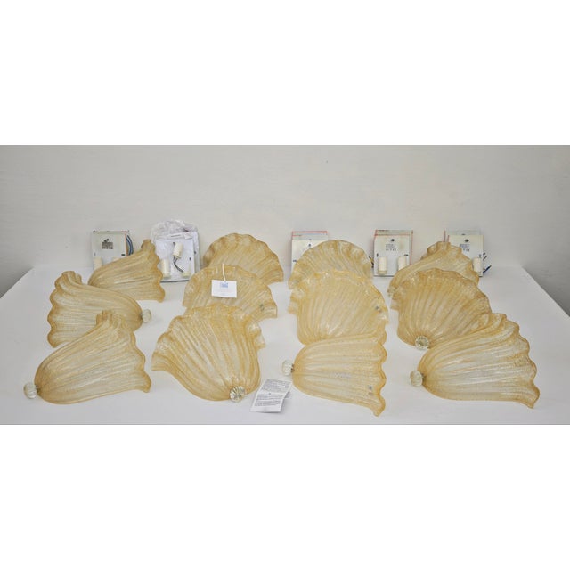 Set of 11 wall sconces by aureliano toso in hand-blown murano glass, featuring a refined italian design. They feature a...