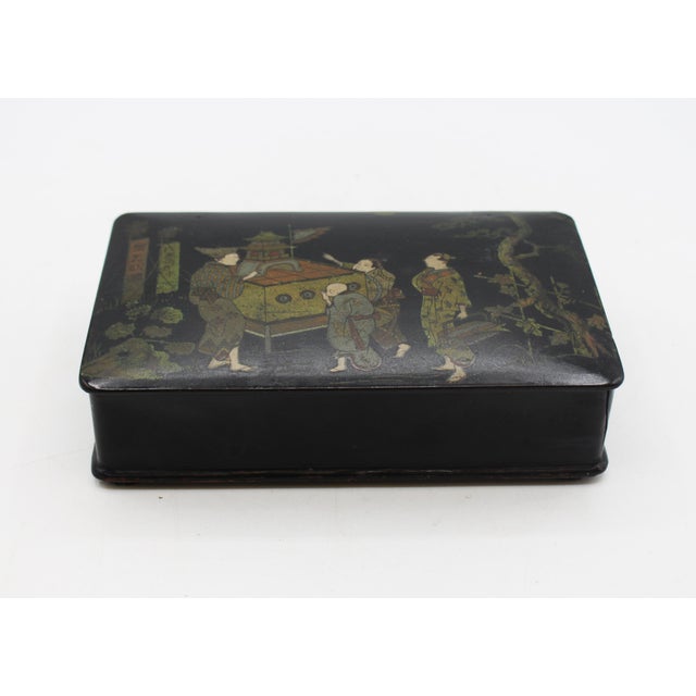 Circa 1870 Meiji era lacquer & papier mache box, Japan. Black with red divided interior. Painted with a fascinating scene...