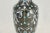 Early 20th Century Chinese ebony noir cloisonné vintage vase hand decorated with a floral design in aqua, blue, yellow and...
