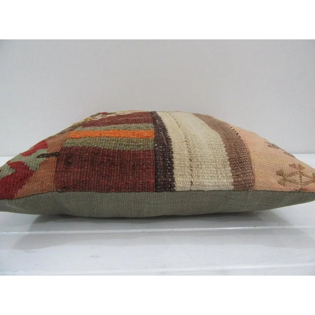 This is a pillow cover made from a vintage kilim rug. The piece was properly washed and ready to use. Pillow inserts not...