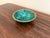 A beautifully proportioned brass rimmed malachite bowl in richly veined shades of green and black. The sculptural...