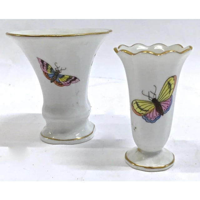 Pair of small Herend porcelain wild bird and butterfly illustrated bud vases. Wild birds hand painted on front and...