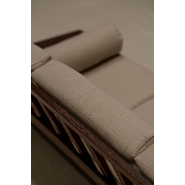 Vintage mid-century three seat sofa. Constructed out of a solid wengé wooden frame combined with freshly re-upholstered...