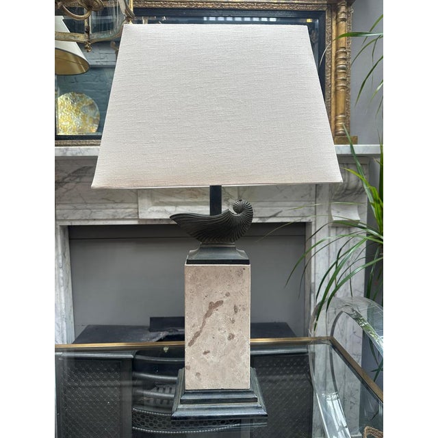 A large table lamp in Travertine and Bronze. The stepped base in patinated verdigris bronze with a large rectangular block...