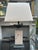 A large table lamp in Travertine and Bronze. The stepped base in patinated verdigris bronze with a large rectangular block...