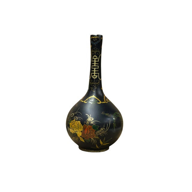 This elegant long-necked globular vase features a striking matte black finish, serving as a dramatic canvas for its...
