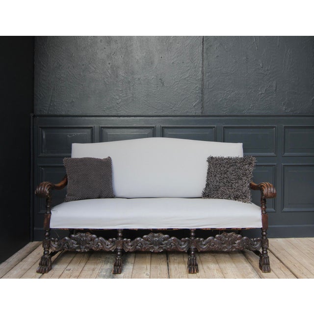 A late 19th century German historicism 3-seater sofa. Made of walnut with upholstered seat and backrest. Standing on a...