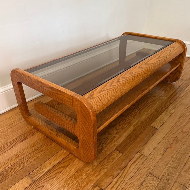 1970s Mid-Century Modern Lou Hodges oak coffee table. Classic California modern design with curved lines, smoked glass...