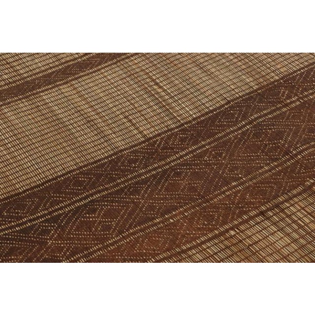 This vintage floor covering is a rare oversized 14x17 Tuareg mat from the nomadic tribal weavers of the same name....