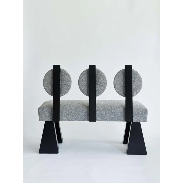 Made to order bouclé and wood settee designed by Christian Siriano. Fabric for seat/back cushion: Gray Bouclé Base: Black...