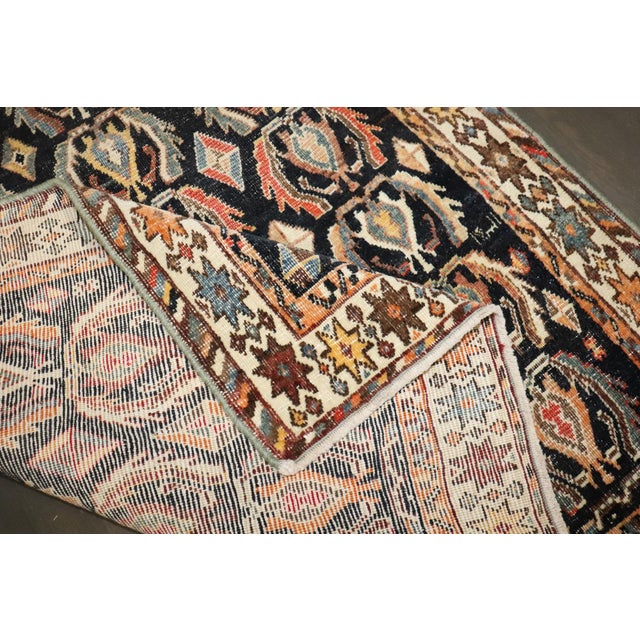 A persian antique shiraz throw rug from the early 20th century