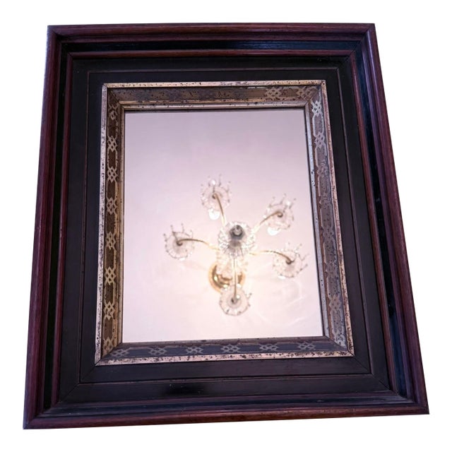 Early 20th‑Century American walnut wall mirror with a narrow gold‑gilt molded frame — warm walnut grain meets subtle gilt...