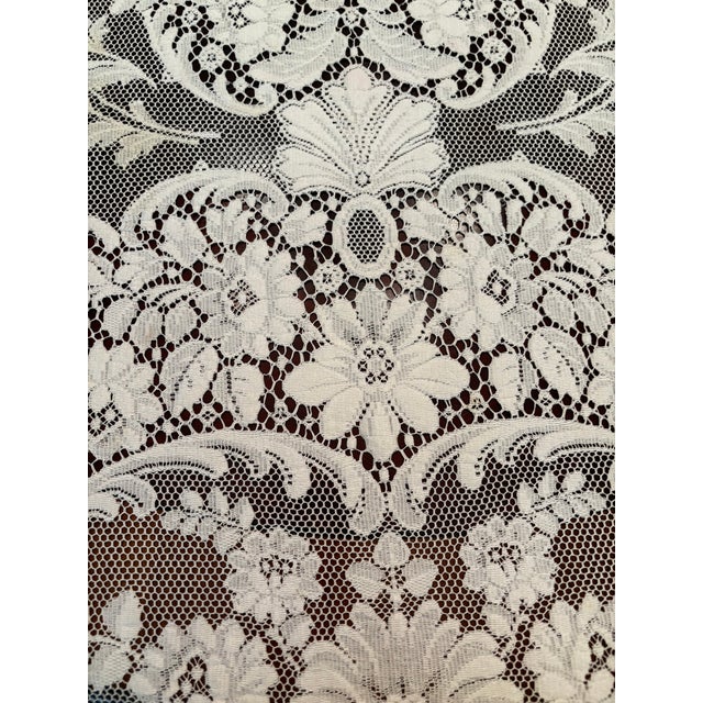 This delicate 1950’s lace table cloth features an intricate floral and medallion design. It is machine made lace which is...