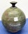 Noted ceramic pottery maker, Andrew Berend spun the texture on this striking ceramic vessel or bud vase in a mutli hue...