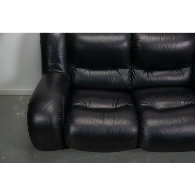 Space age Italian sofa made from high quality black leather and chrome detailing. The sofa sits two people comfortably...