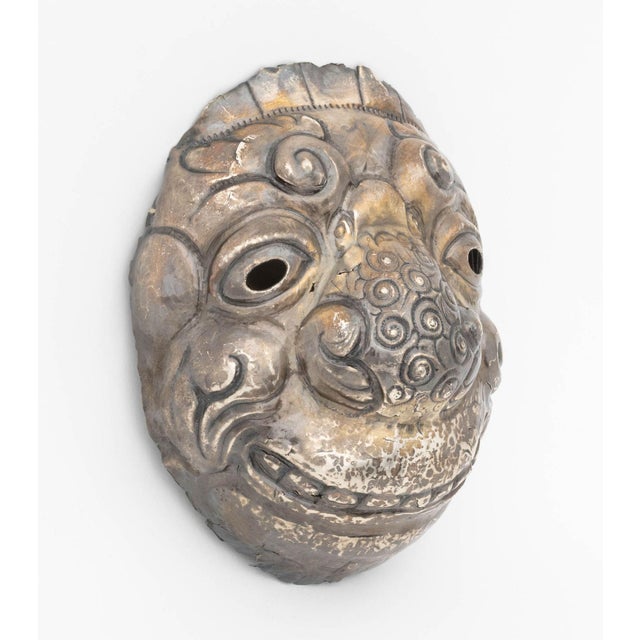 Peruvian Repousse-Decorated Silver Mask, the head with horns and scroll decoration to the nose. Weight: 6.30 ozt.; 9" H x...