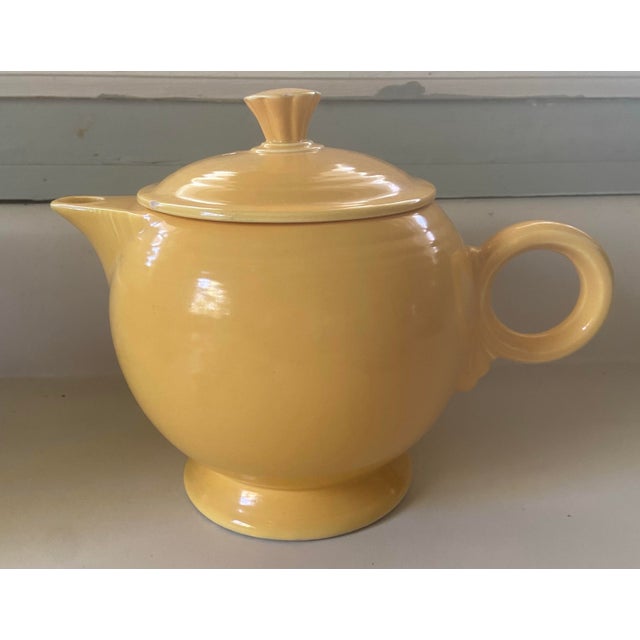 Vintage Fiesta yellow teapot with classic rounded body, pedestal base, ring handle, and fitted lid. Finished in one of...