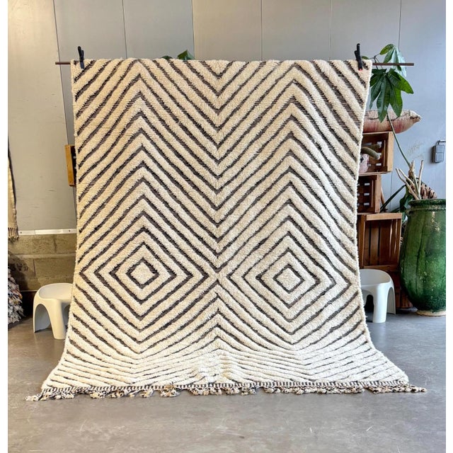 Bring timeless elegance into your home with this Moroccan Mrirt wool rug, handcrafted by skilled Berber artisans from the...