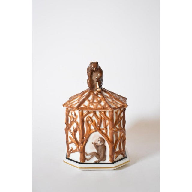 Tobacco box with forest animals, 1910s. Covered porcelain jar, covered pot, with canted sides, glazed with a relief...