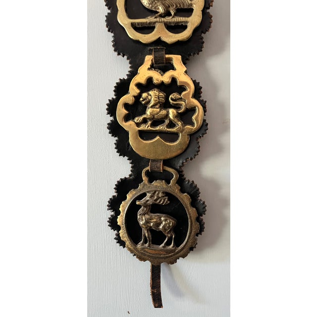 This leather strap was hung from horse saddles/harnesses during parades or other special events. Some of the medallions...