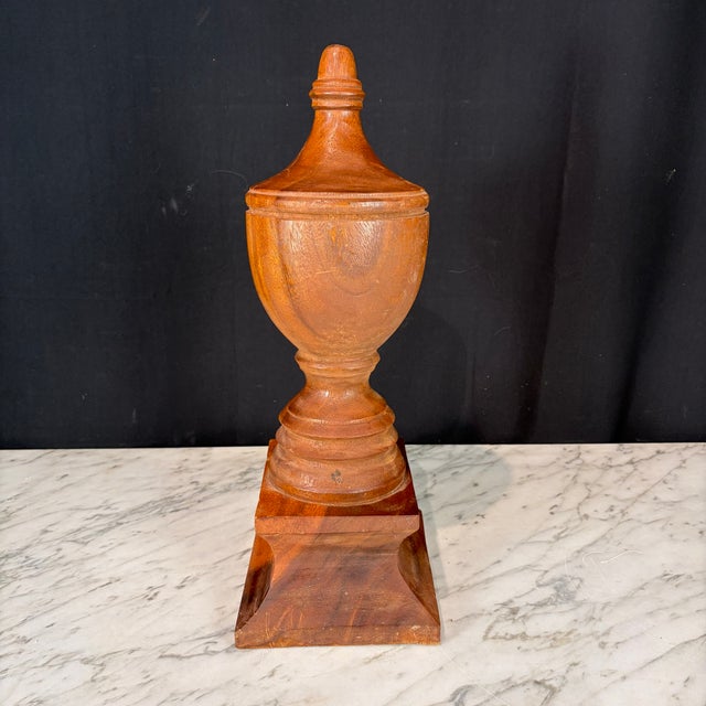 Large architectural wooden finial, finely turned with a classic urn-form silhouette, stepped socle base and original warm...