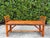 A beautifully crafted vintage split bamboo hall bench featuring woven cane end panels, gently arched supports, and a warm...