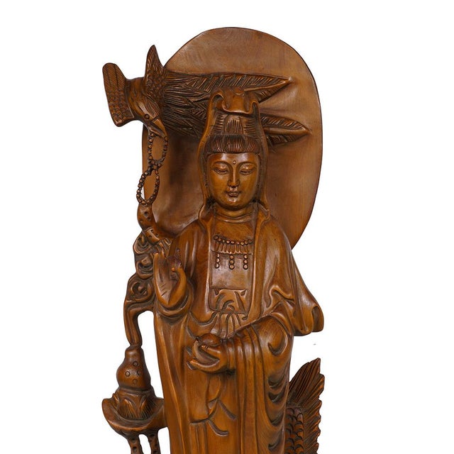This item is a hand-carved wooden statue of Guanyin (also known as Kwan Yin or Quan Yin), the Bodhisattva of Compassion....