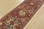 A traditional Suzani runner hand-knotted with fine wool on a cotton foundation. This rug features medallions surrounded by...