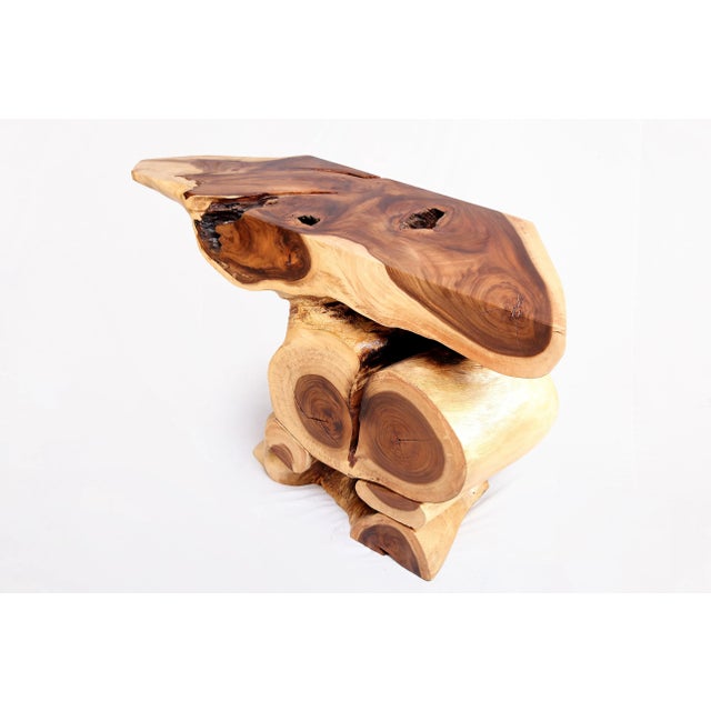 Inspired by the beauty of natural wood form and grain, this organic console table is handcrafted from one piece of wood....