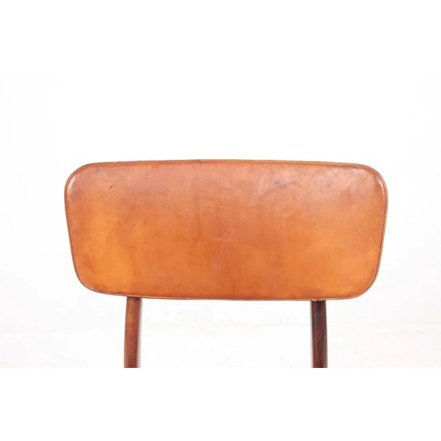 Side chair in rosewood and patinated leather, designed by Kai Kristiansen and made by Gustav Bertelsen cabinetmakers....