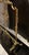 An antique fireplace screen in the Louis XVI style with Rococo elements. The brass frame features ribbons, leaves,...