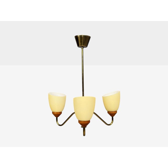 Swedish Mid-Century Modern, Pendant Light, Teak, Brass, Glass, Sweden, 1950s A three light pendant light possibly designed...