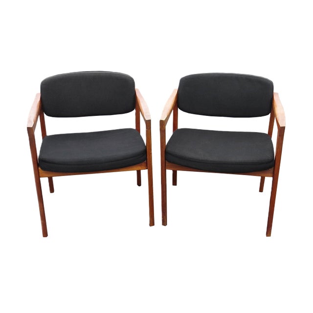 A pair of vintage mid-century Eck-Adams armchairs. Solid walnut frame with a slight inward bevel on the front legs....