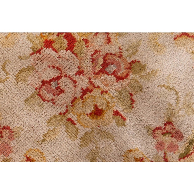 This magnificent Oversized Antique French Savonnerie rug, dating back to the early 20th century, is a celebration of...