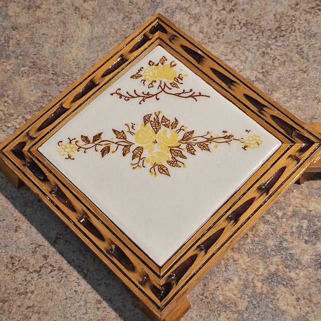 Circa 1970s Orion Monterrey Mexico Ceramic Wood Handled Floral Vine Design Trivet. Size: 13" x 6" Very Good Condition....
