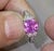 14k White gold ring with GIA certified 2.18 carat cushion-cut hot pink sapphire. Half moon-cut white diamonds weighing...