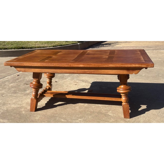 Nice oak refectory dining table with a planked top, turned legs and draw leafs. The table features a trestle base with...