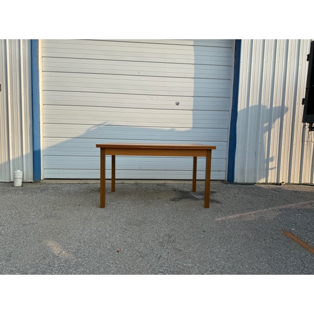 Vintage Danish Modern extendable dining table featuring classic Scandinavian styling, warm teak tones, clean lines, and a...