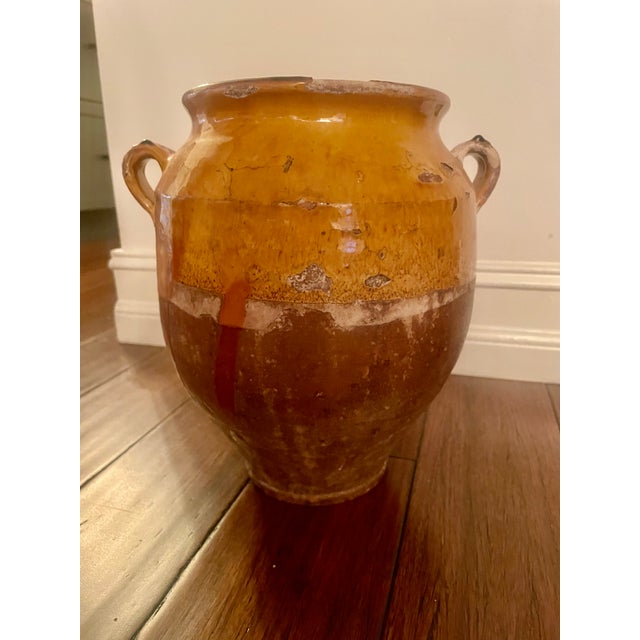 Authentic antique French confit pot dating to the late 19th century. This classic piece features a rich golden carmel-...