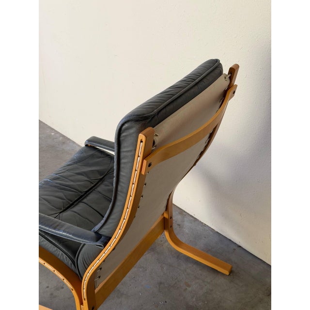 Norwegian lounge chair featuring soft grey leather upholstery and a beautifully sculpted bentwood frame. This piece...
