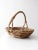 This vintage wicker basket features a rounded body and gracefully twisted handle, showcasing the natural beauty of...