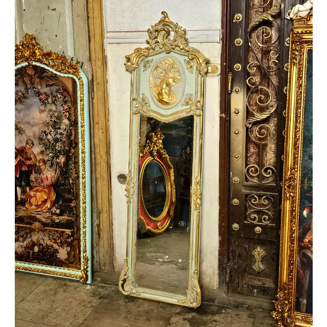 Bring an elegant touch of French-inspired luxury to your interior with this striking Rococo-style wall mirror. The frame...