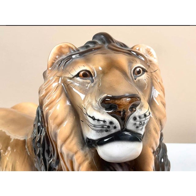 A striking vintage Italian ceramic sculpture depicting a reclining male lion in a classic recumbent pose. Substantial in...