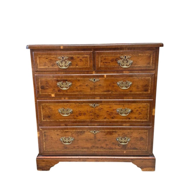 Small William and Mary style chest with fine mahogany and burl veneers and banding. The chest has 5 drawers with burl...