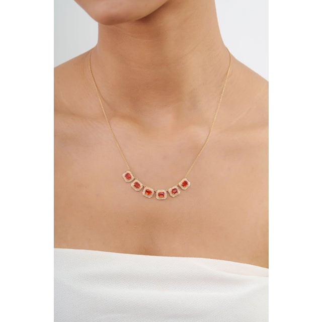 This art deco style station necklace showcases 2.67 carats of emerald-cut orange sapphires, set in 14K yellow gold. Each 5...